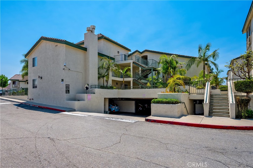 15000 Downey Avenue, Unit 343 Paramount, CA 90723 - Photo 32 of 39 a front view of a house with glass windows and yard