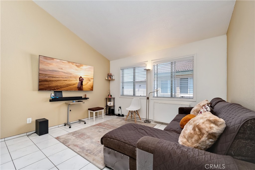 15000 Downey Avenue, Unit 343 Paramount, CA 90723 - Photo 8 of 39 a living room with furniture and a flat screen tv