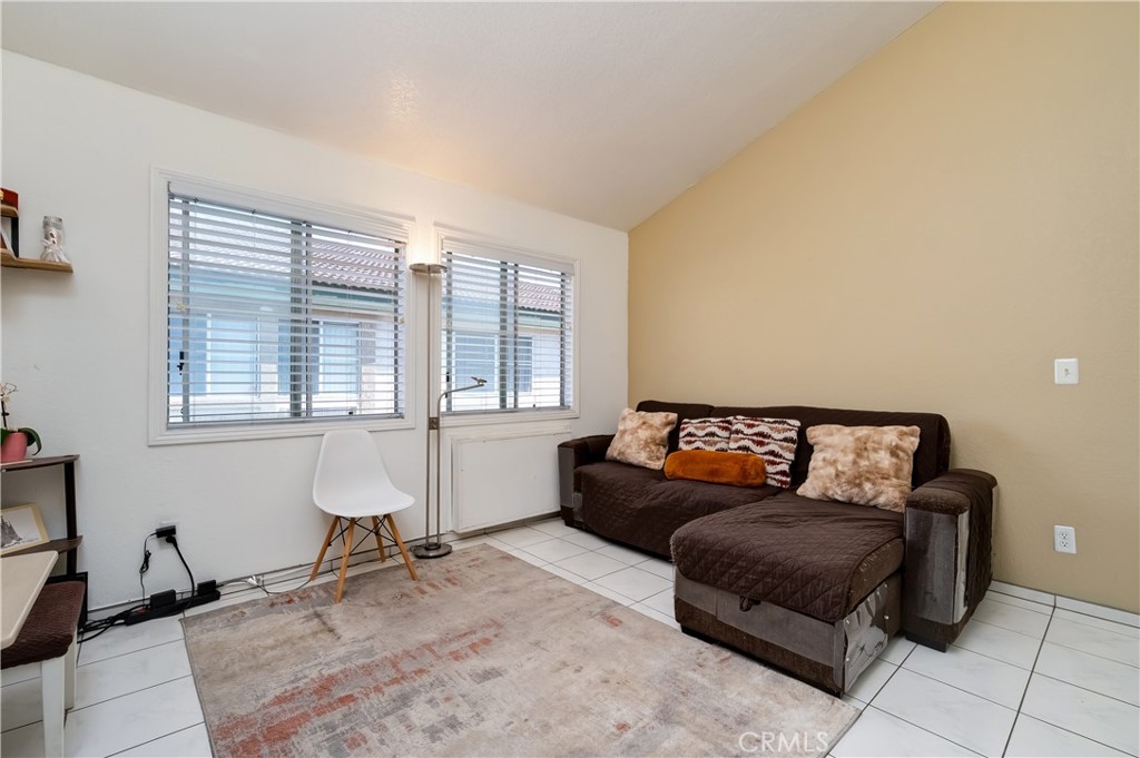 15000 Downey Avenue, Unit 343 Paramount, CA 90723 - Photo 10 of 39 a living room with furniture and a window