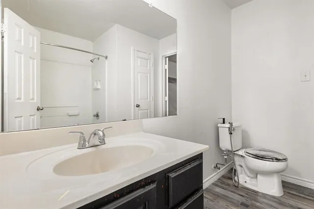 a bathroom with a sink toilet and a mirror