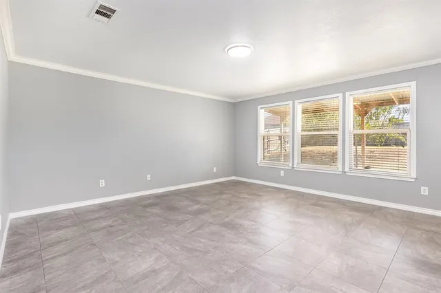a view of an empty room with a window