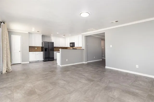 a view of a kitchen with a refrigerator and a microwave