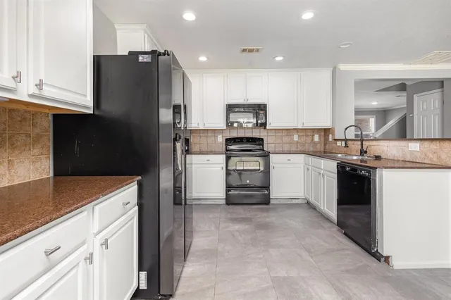 a kitchen with stainless steel appliances a refrigerator sink and microwave