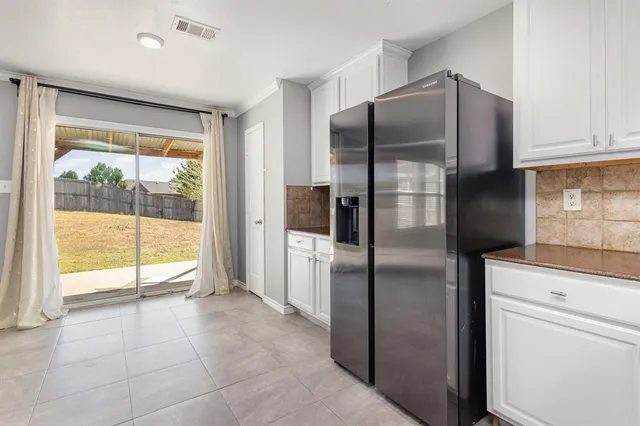 a kitchen with stainless steel appliances a refrigerator sink and cabinets