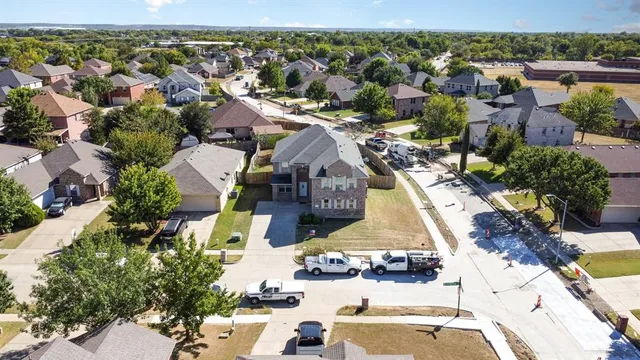 an aerial view of residential houses with outdoor space and parking