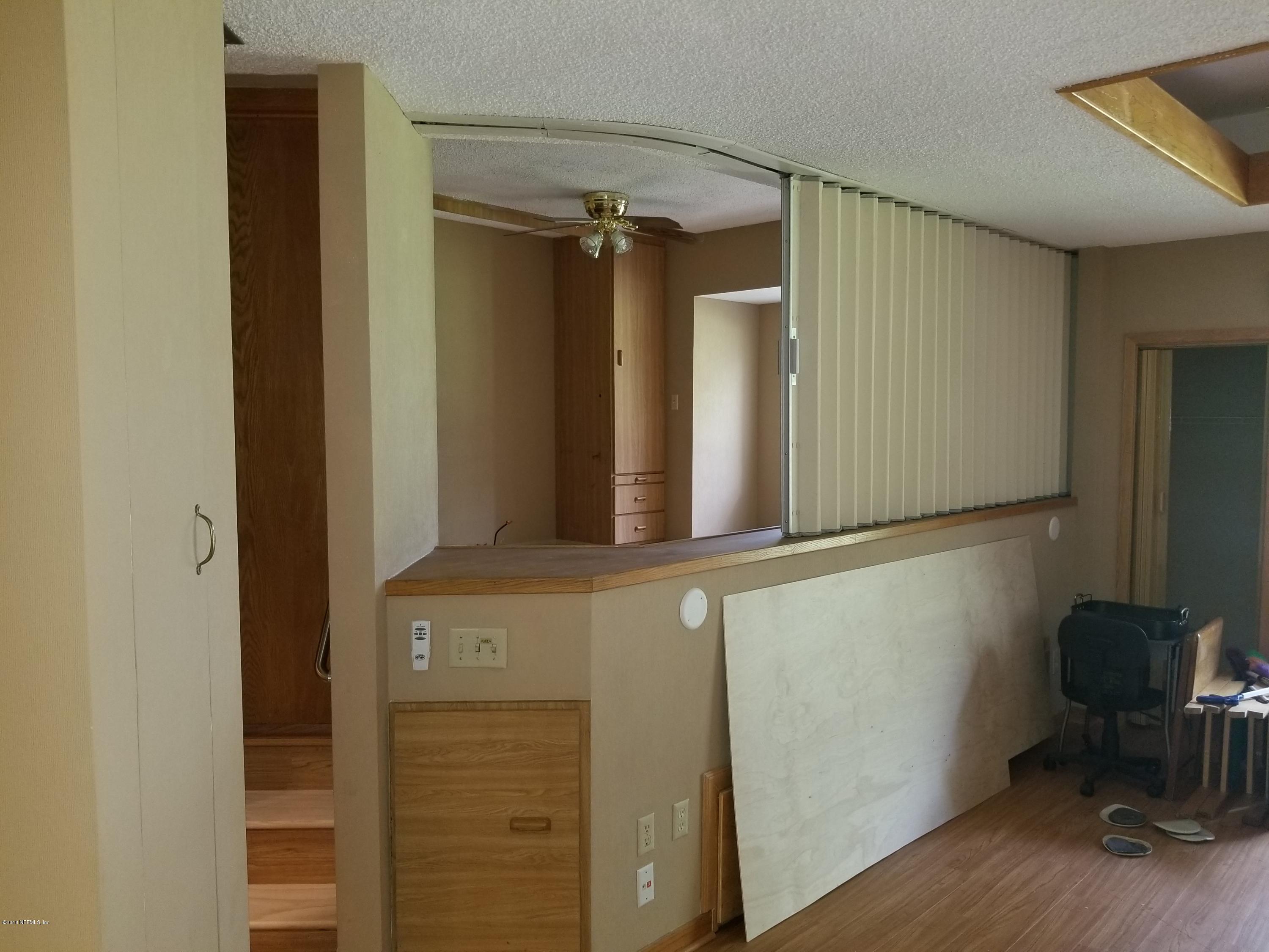 3175 Ravines Road, Unit 3703 Middleburg, FL 32068 - Photo 6 of 13 a view of a door and chair in a room