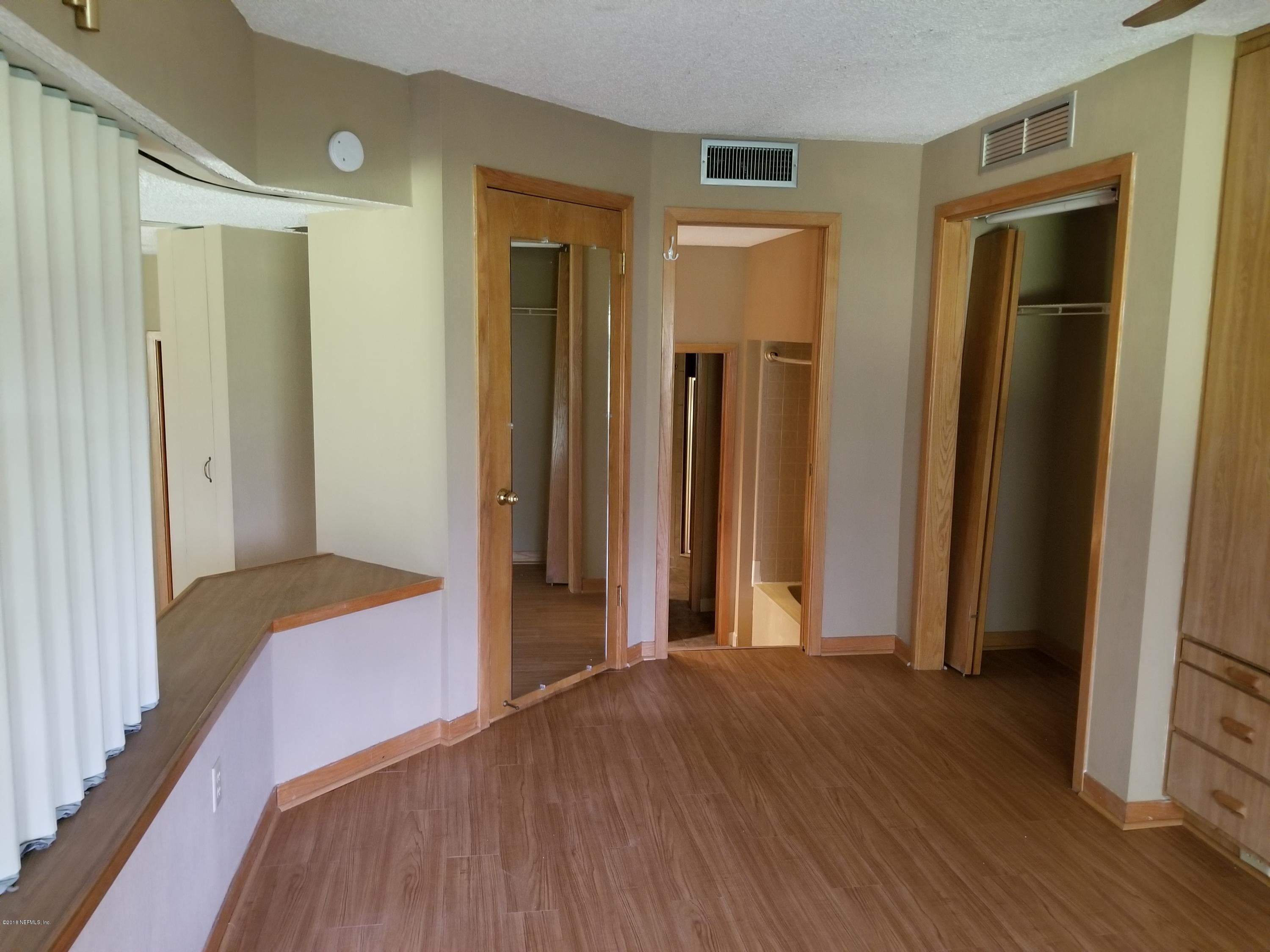 3175 Ravines Road, Unit 3703 Middleburg, FL 32068 - Photo 8 of 13 a view of a hallway with wooden floor and closet area