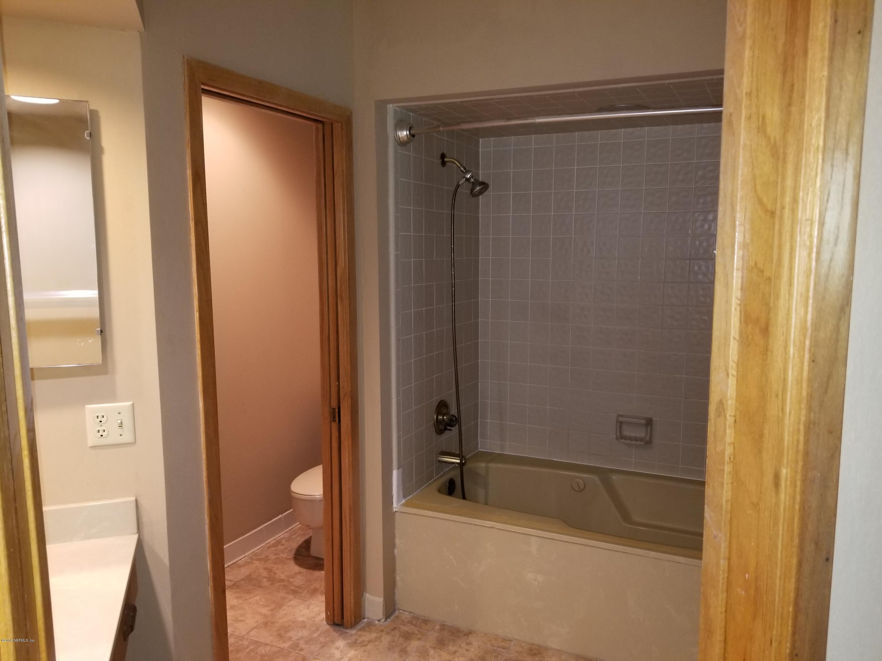 3175 Ravines Road, Unit 3703 Middleburg, FL 32068 - Photo 9 of 13 a bathroom with a tub and shower