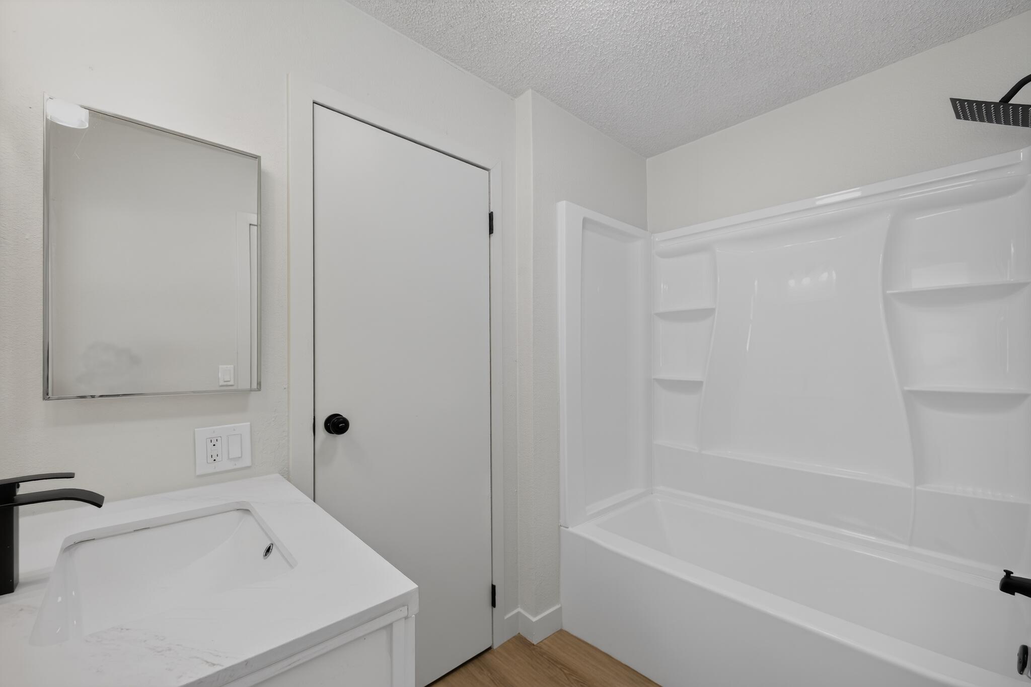 15181 Van Buren Boulevard, Unit 102 Riverside, CA 92504 - Photo 19 of 29 a bathroom with a bathtub and a shower