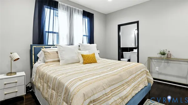 a bedroom with a bed and wooden floor