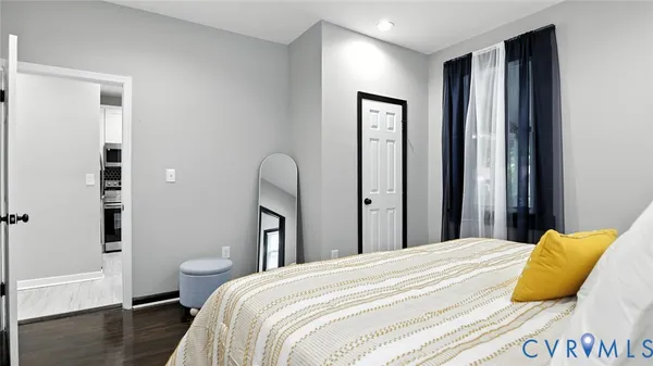 a bedroom with a bed and wooden floor