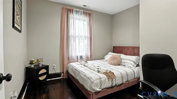 a bedroom with a bed and a desk