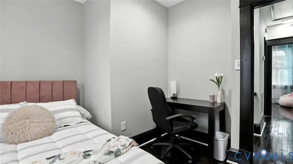 a view of a hallway with wooden floor and stairs