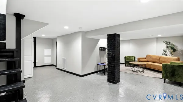 a living room with furniture and a potted plant