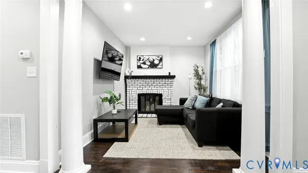 a living room with furniture and a fireplace