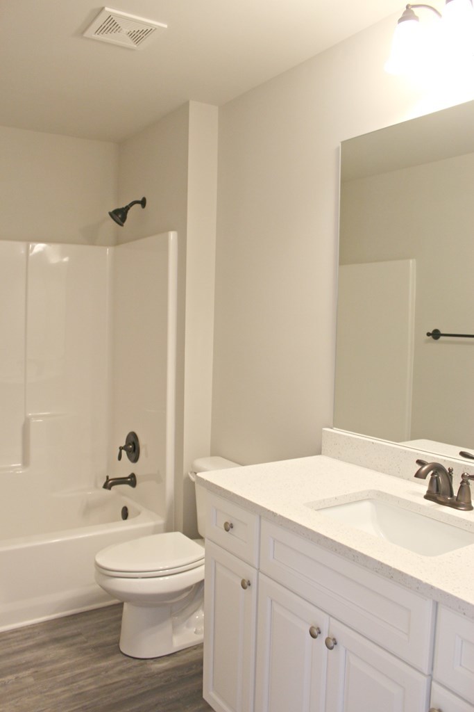 965 Weldon Road Forsyth, GA 31029 - Photo 11 of 11 a bathroom with a toilet a sink a mirror and bathtub