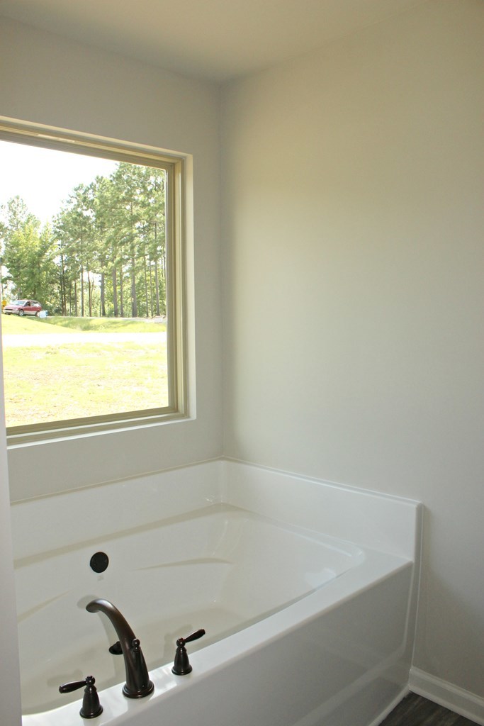 965 Weldon Road Forsyth, GA 31029 - Photo 8 of 11 a bathroom with a bathtub and window