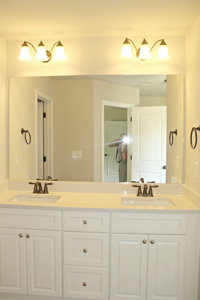 965 Weldon Road Forsyth, GA 31029 - Photo 9 of 11 a bathroom with a sink and a mirror