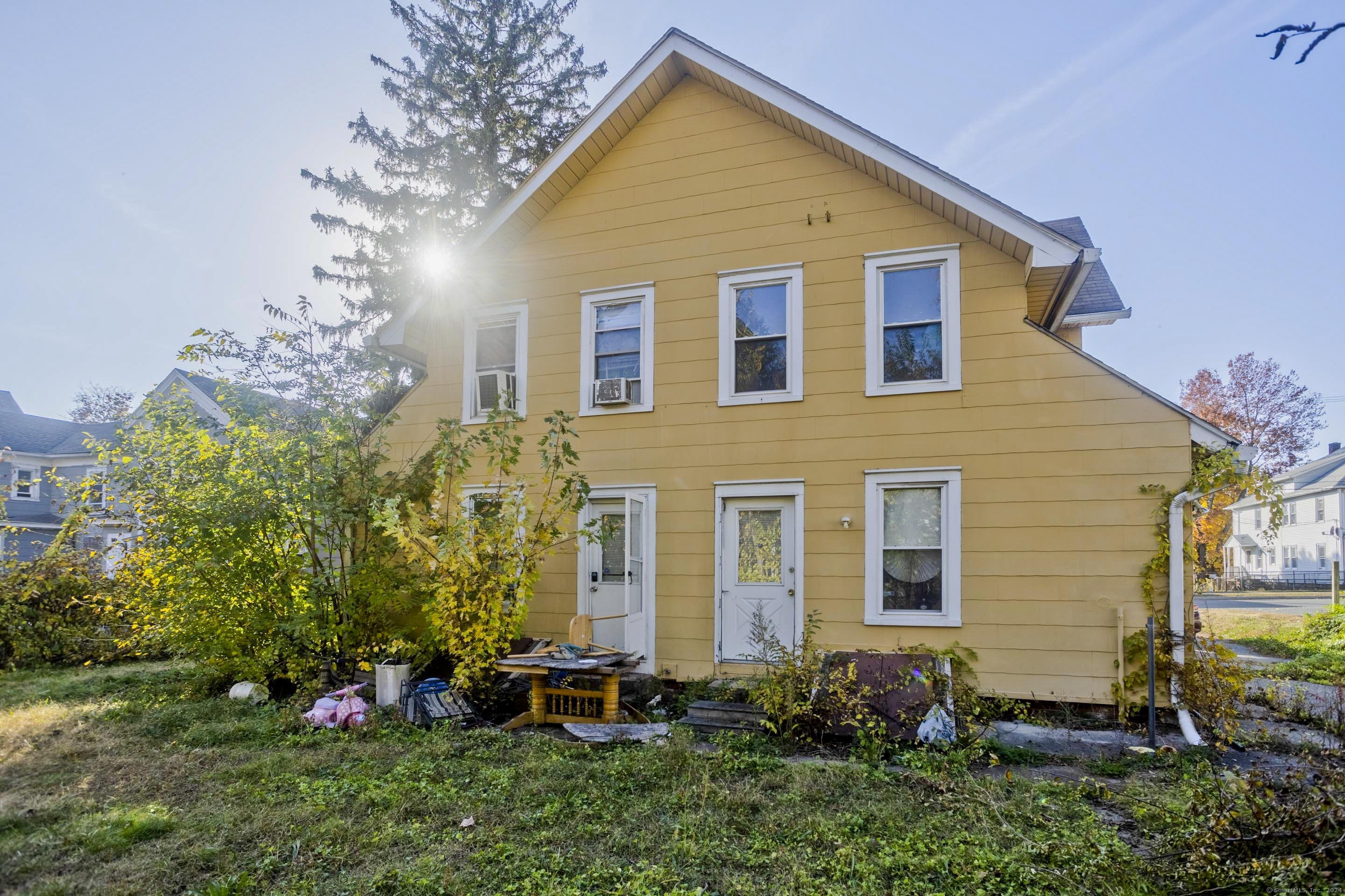 69 Prospect Street Enfield, CT 06082 - Photo 3 of 14 a view of backyard with plants and outdoor seating