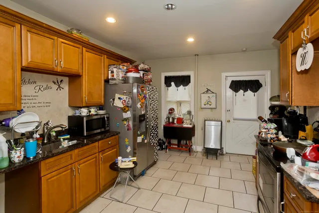 a view of a kitchen with fridge and workspace