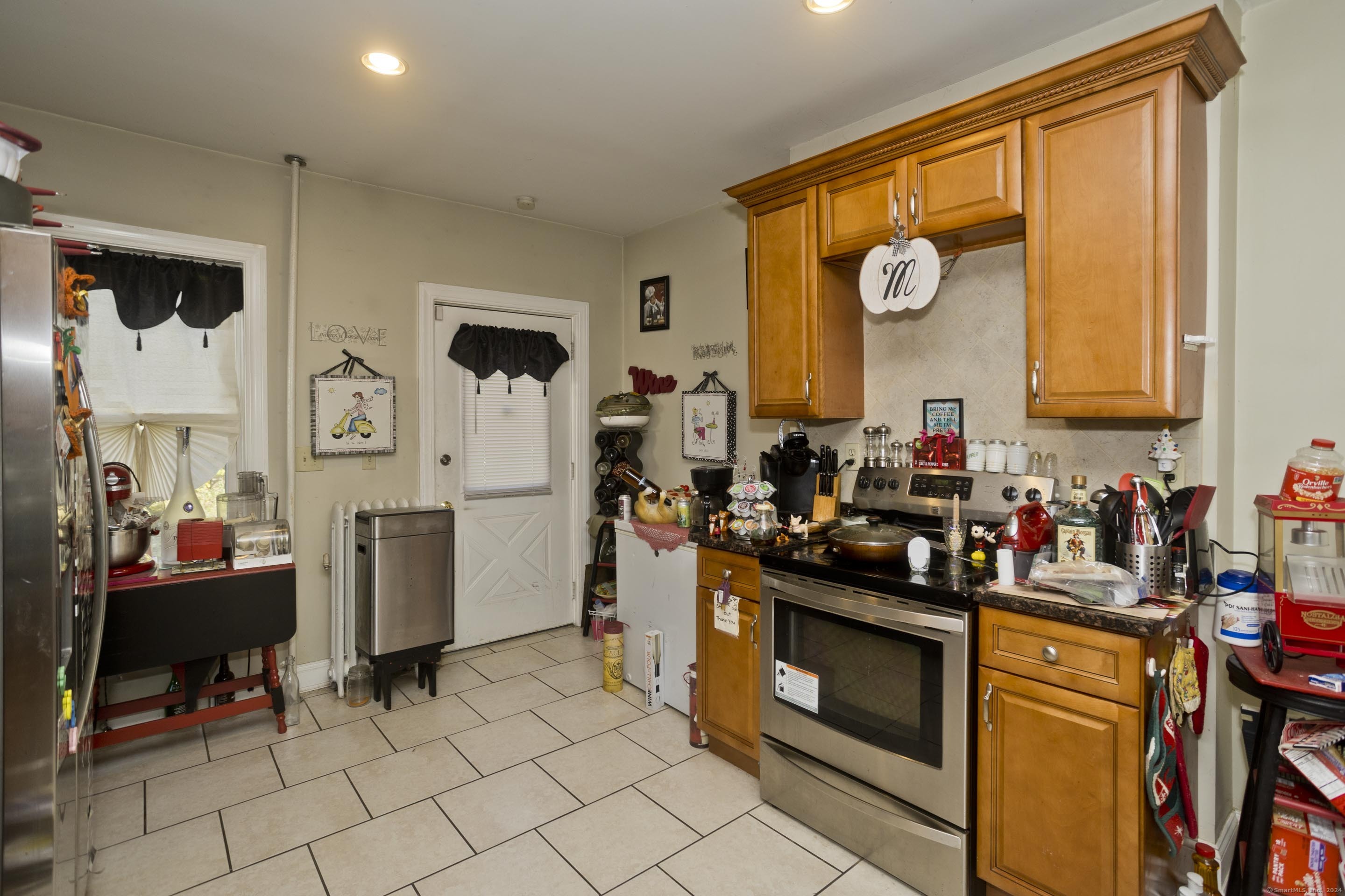 69 Prospect Street Enfield, CT 06082 - Photo 6 of 14 a view of a kitchen with fridge and workspace