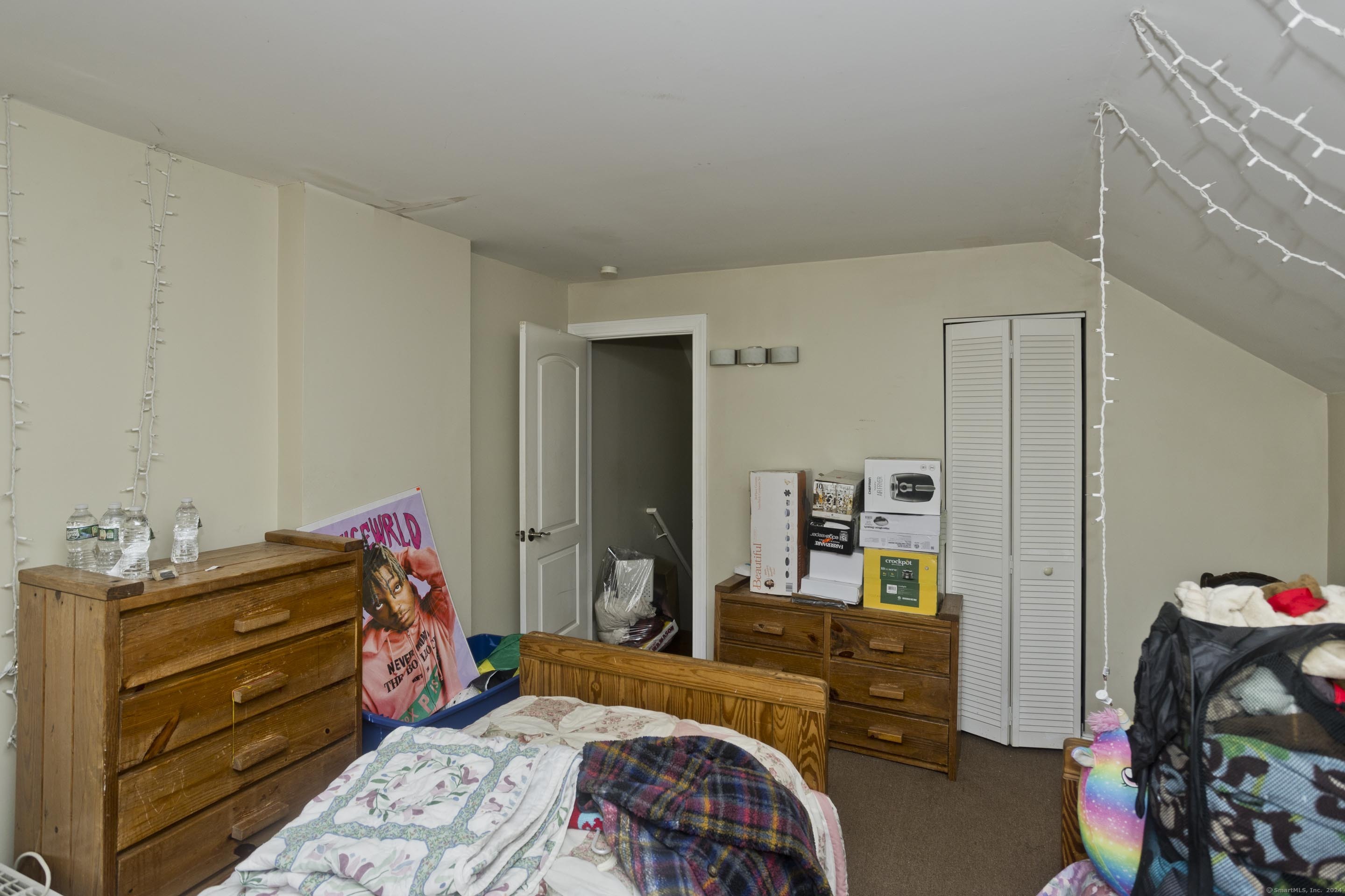 69 Prospect Street Enfield, CT 06082 - Photo 8 of 14 a bedroom with a bed and wooden floor