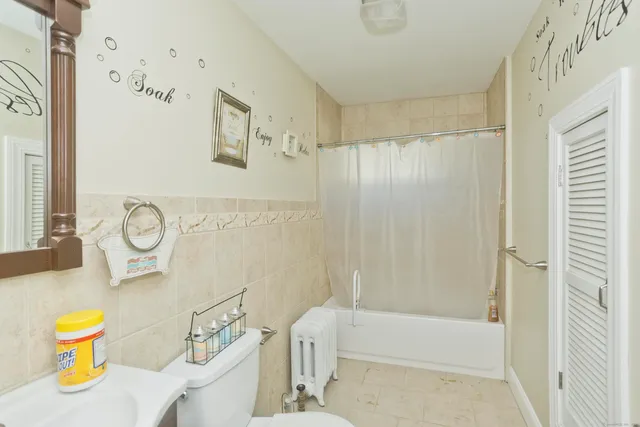 a bathroom with a sink a toilet and shower curtain