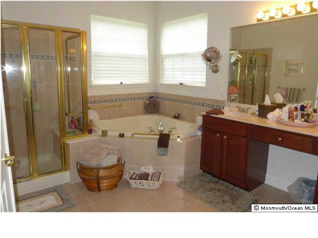 8 Nottingham Way Jackson, NJ 08527 - Photo 11 of 24 a bathroom with a sink mirror and a bathtub