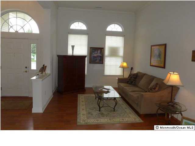 8 Nottingham Way Jackson, NJ 08527 - Photo 3 of 24 a living room with furniture and a large mirror next to a window
