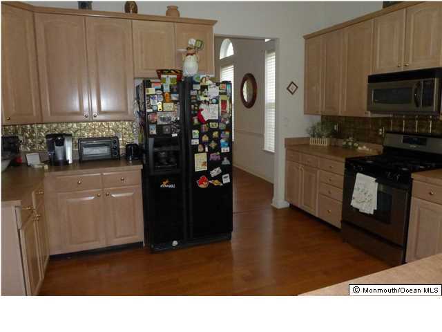 8 Nottingham Way Jackson, NJ 08527 - Photo 4 of 24 a kitchen with stainless steel appliances kitchen island granite countertop a refrigerator a stove top oven a sink and dishwasher