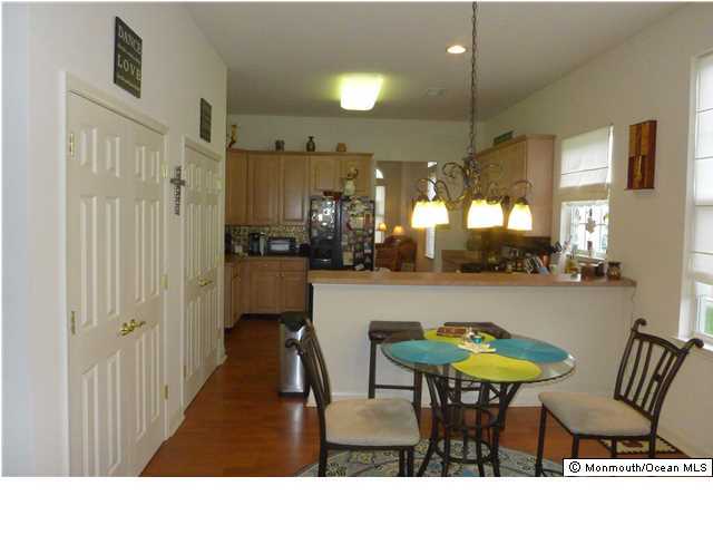 8 Nottingham Way Jackson, NJ 08527 - Photo 5 of 24 a kitchen with a table chairs and a painting