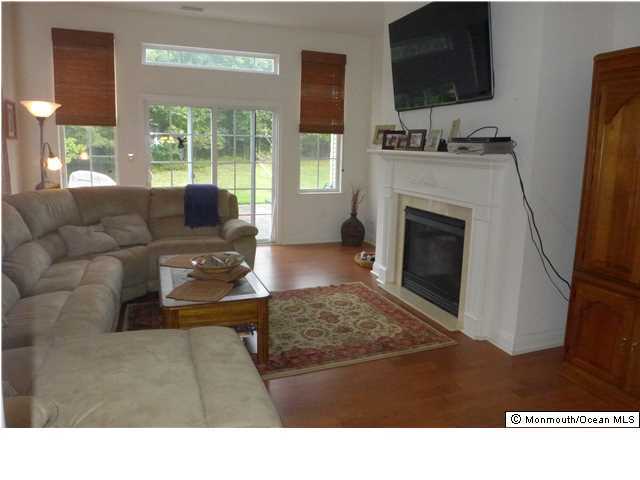 8 Nottingham Way Jackson, NJ 08527 - Photo 9 of 24 a living room with furniture and a fireplace