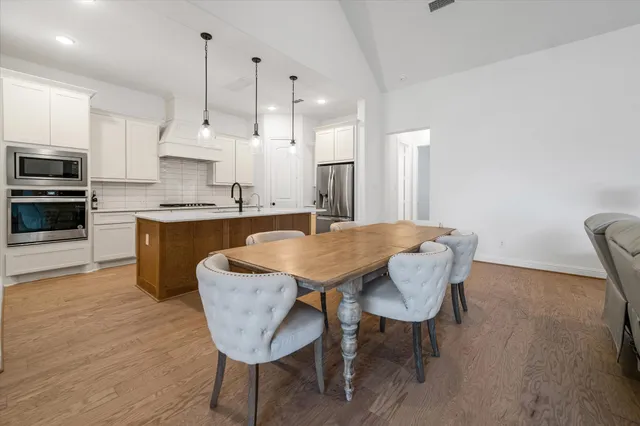 a large kitchen with a table and chairs in it
