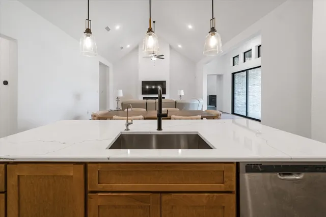 a close view of kitchen sink a counter space and stainless steel appliances