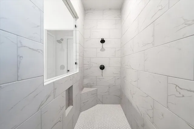 a bathroom with a toilet and shower
