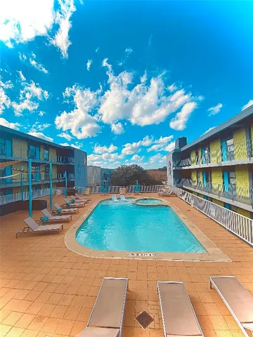 a swimming pool with outdoor seating