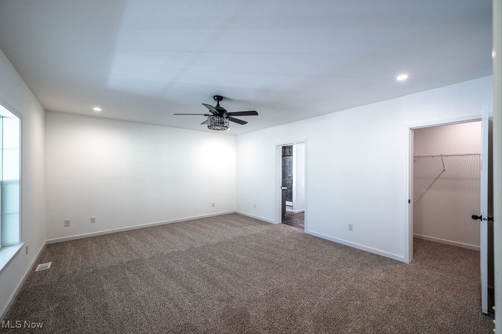7343 Lost Pavement Road Belleville, WV 26133 - Photo 13 of 49 Unfurnished bedroom with recessed lighting, carpet flooring, a spacious closet, and a ceiling fan