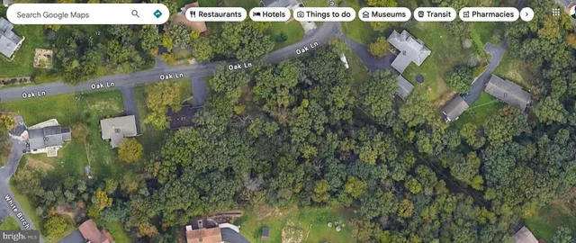 an aerial view of a houses with a yard