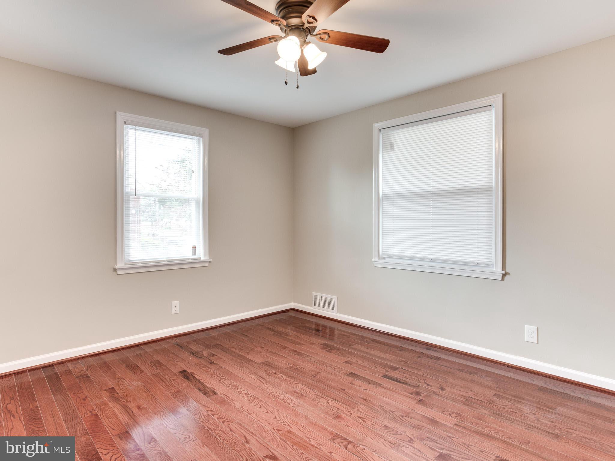 3529 Wild Cherry Road Baltimore, MD 21244 - Photo 15 of 30 a view of an empty room with wooden floor and a window