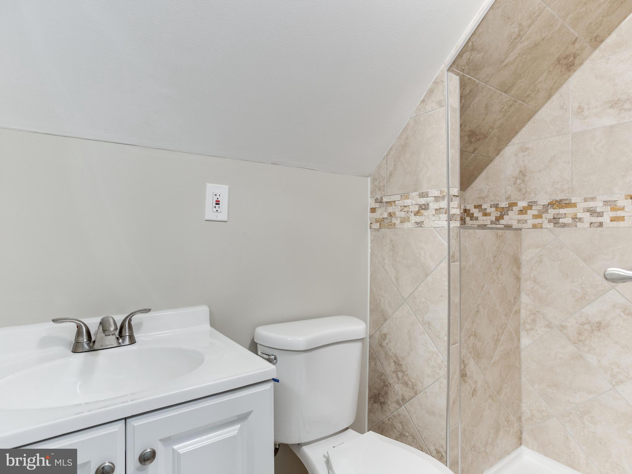 3529 Wild Cherry Road Baltimore, MD 21244 - Photo 20 of 30 a bathroom with a sink a toilet and shower curtain
