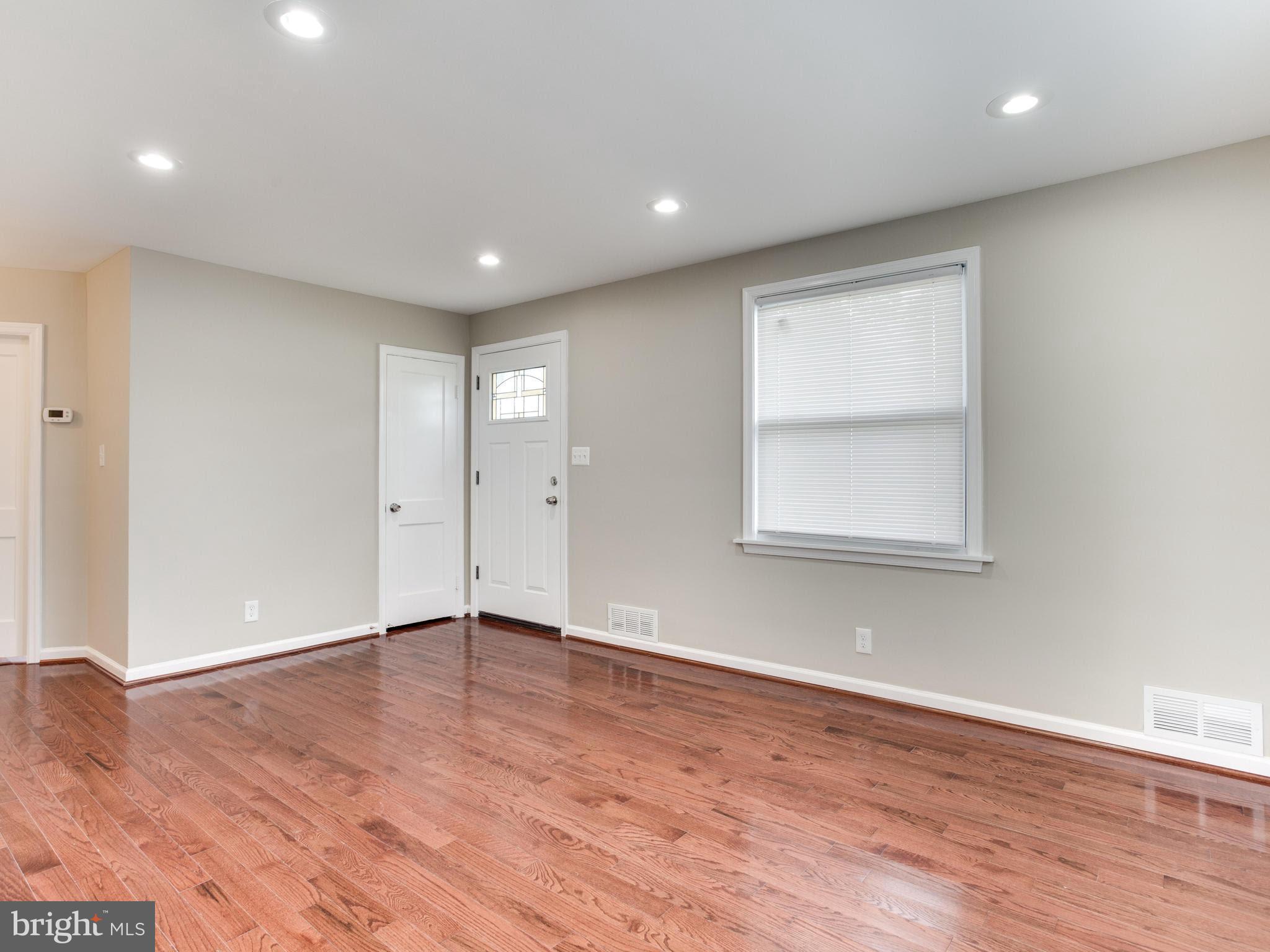 3529 Wild Cherry Road Baltimore, MD 21244 - Photo 3 of 30 a view of an empty room with wooden floor and a window