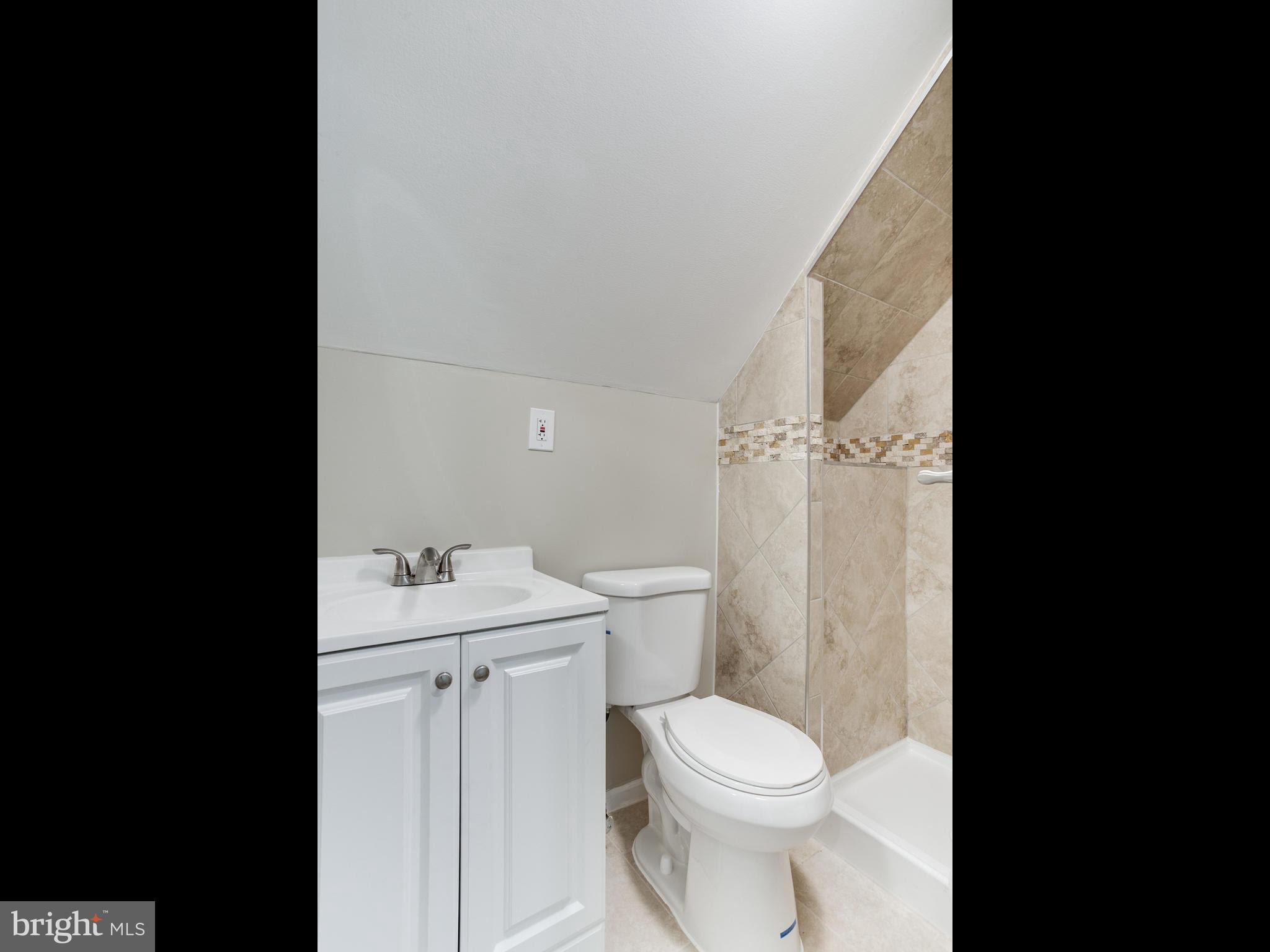 3529 Wild Cherry Road Baltimore, MD 21244 - Photo 21 of 30 a bathroom with a toilet a sink and a bathtub