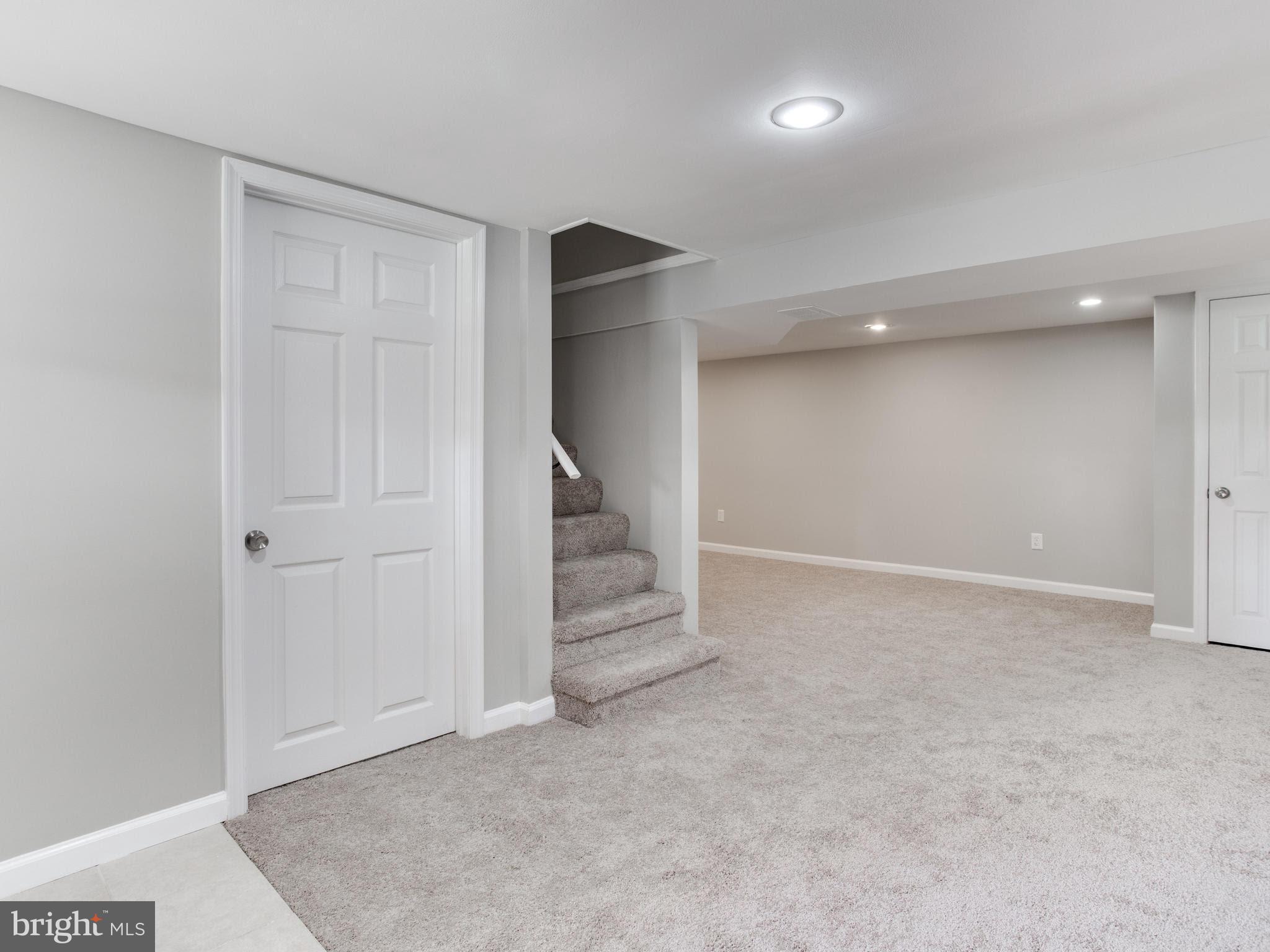 3529 Wild Cherry Road Baltimore, MD 21244 - Photo 24 of 30 an empty room with a hallway and stairs