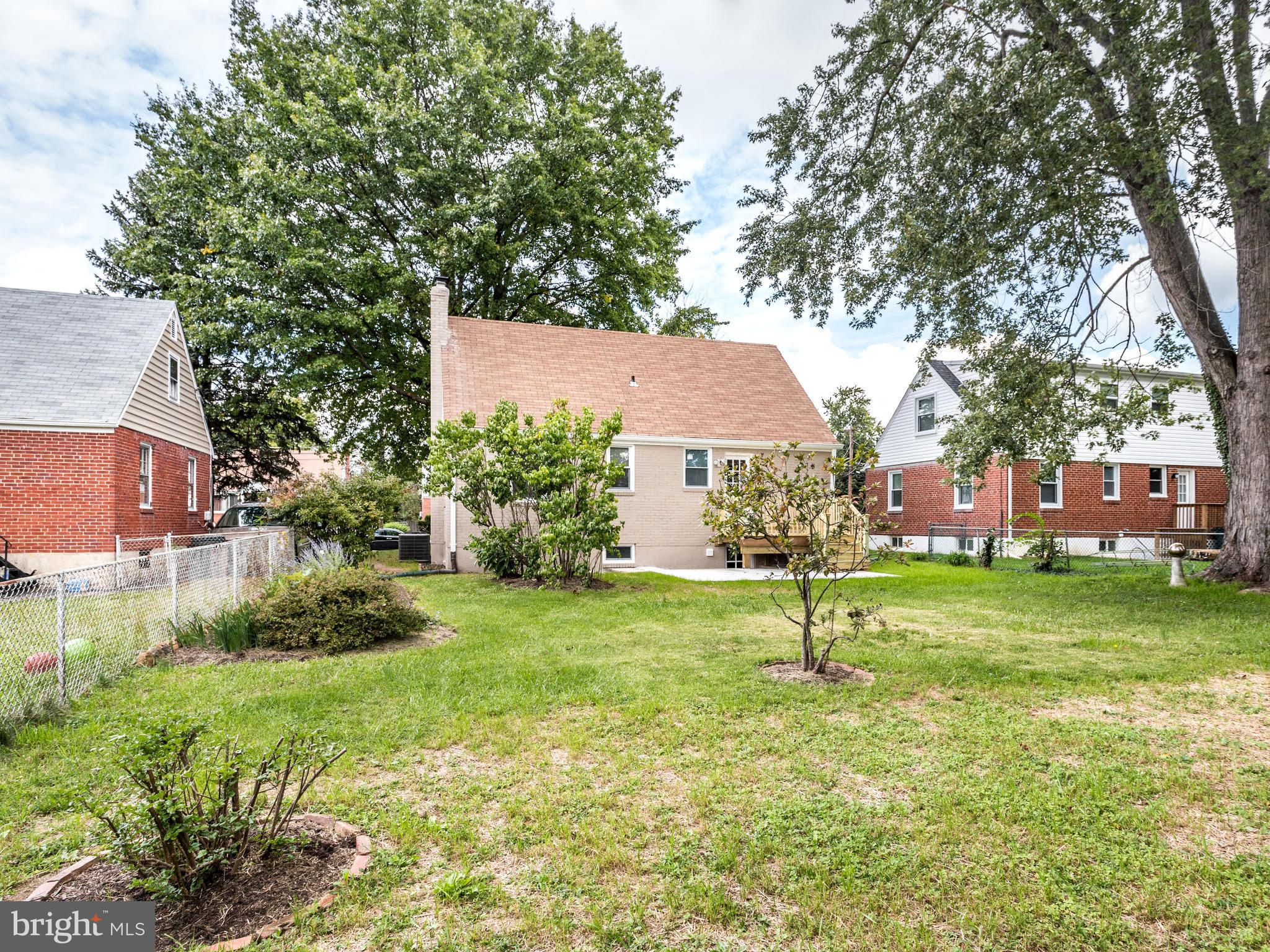 3529 Wild Cherry Road Baltimore, MD 21244 - Photo 28 of 30 a house with a park that has a tree in front of it