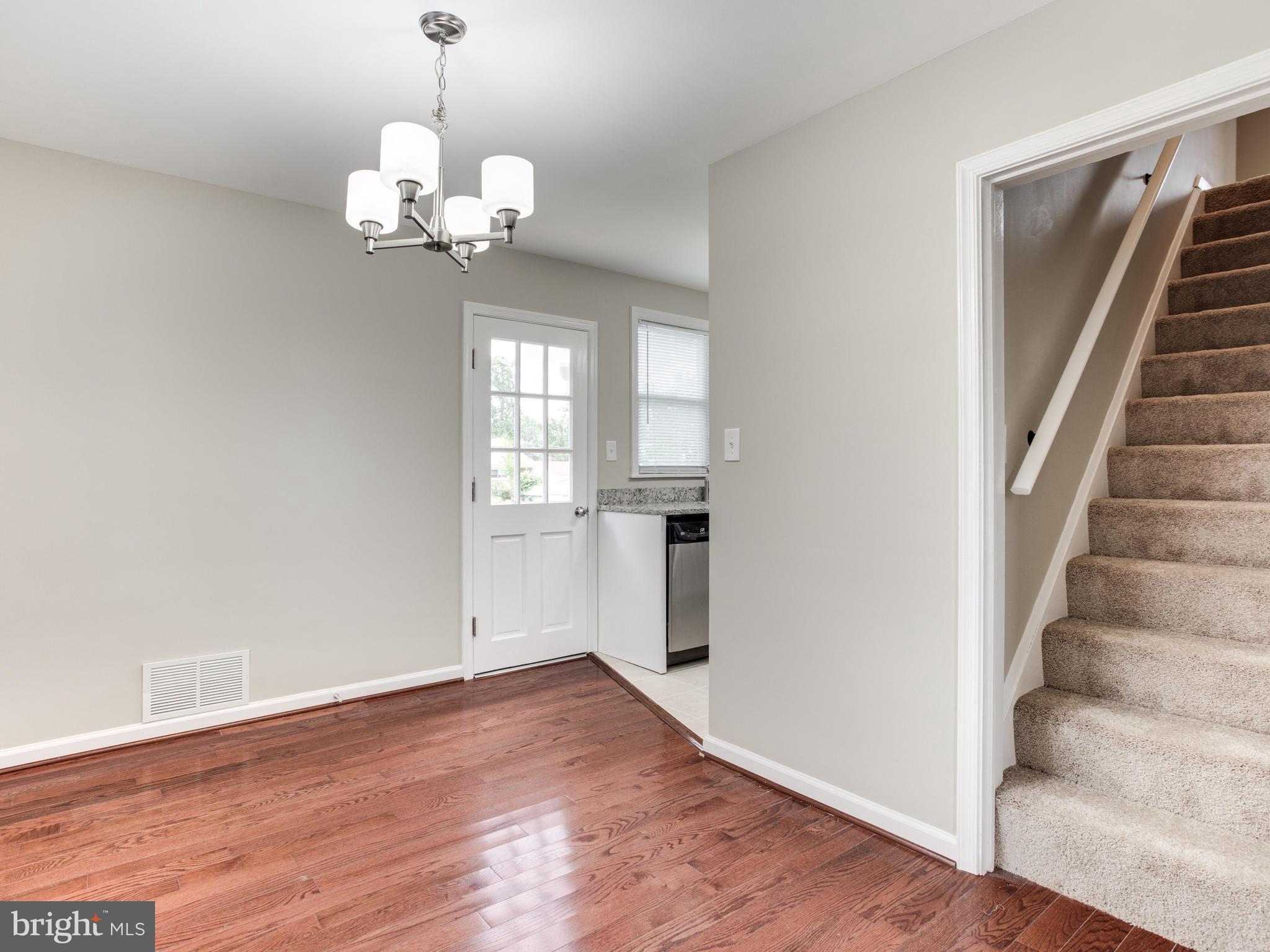 3529 Wild Cherry Road Baltimore, MD 21244 - Photo 4 of 30 a view of an empty room with wooden floor and a window