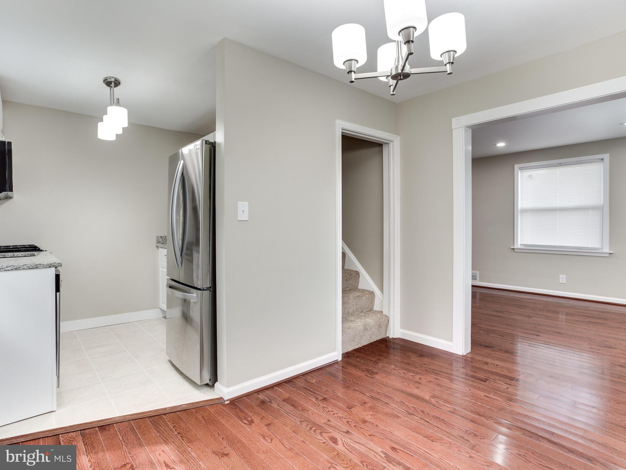 3529 Wild Cherry Road Baltimore, MD 21244 - Photo 6 of 30 a view of a room with wooden floor and chandelier