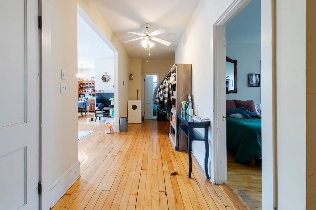 1161 Commonwealth Avenue, Unit 2 Boston, MA 02134 - Photo 11 of 17 a view of a hallway and wooden floor a livingroom with furniture