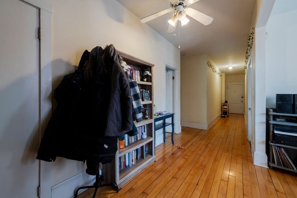 1161 Commonwealth Avenue, Unit 2 Boston, MA 02134 - Photo 12 of 17 a view of a hallway with wooden floor and staircase