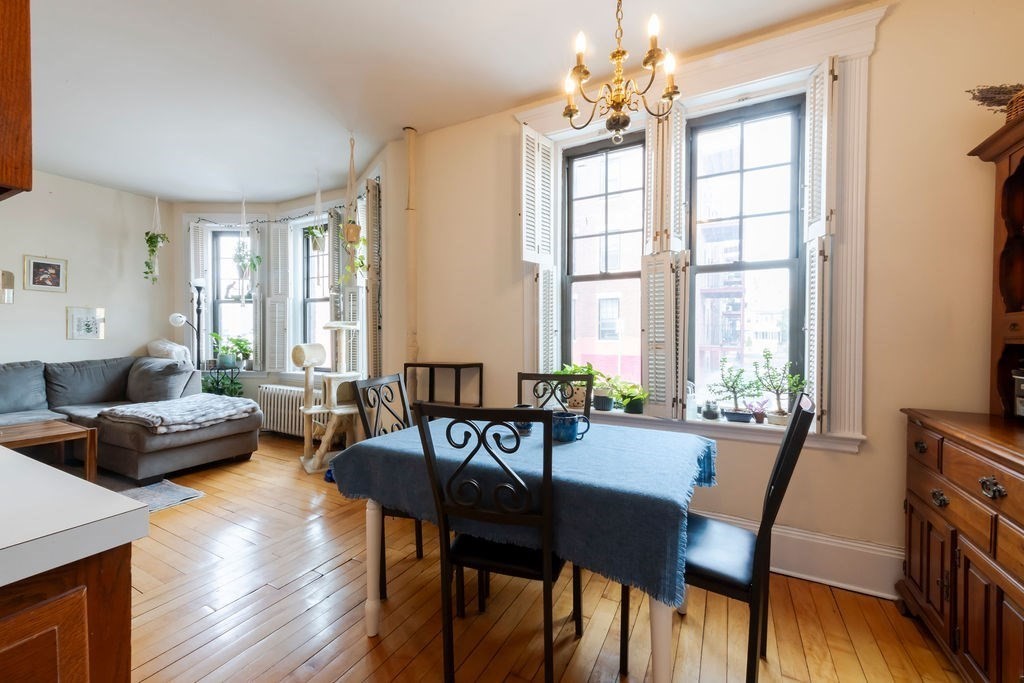 1161 Commonwealth Avenue, Unit 2 Boston, MA 02134 - Photo 7 of 17 a view of a dining room with furniture window and wooden floor