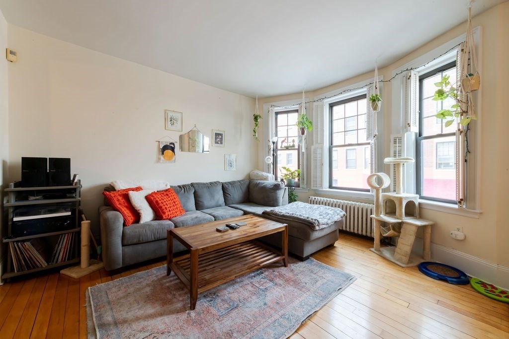 1161 Commonwealth Avenue, Unit 2 Boston, MA 02134 - Photo 8 of 17 a bedroom with furniture and a wooden floor